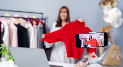 Young,Woman,Selling,Clothes,Online,By,Smartphone,Live,Streaming,,Business