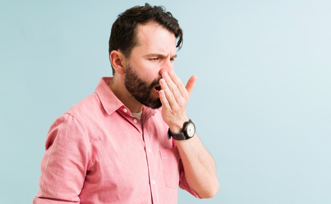 Attractive,Man,Checking,And,Smelling,His,Bad,Breath.,Hispanic,Man