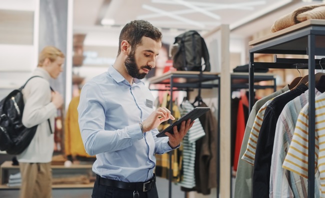 Clothing,Store:,Male,Visual,Merchandising,Professional,Uses,Tablet,Computer,To