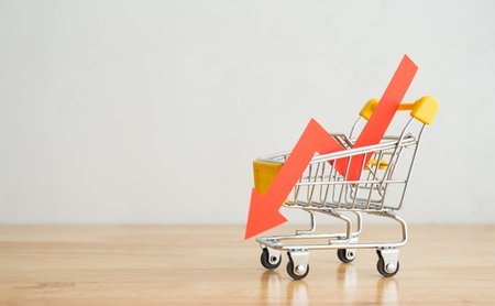 Shopping,Trolley,With,Red,Chart,Falling,Down,On,Wooden,Table