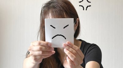 A,Woman,Holding,A,Paper,With,An,Angry,Face,Illustration
