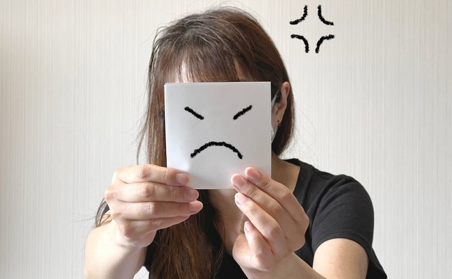 A,Woman,Holding,A,Paper,With,An,Angry,Face,Illustration