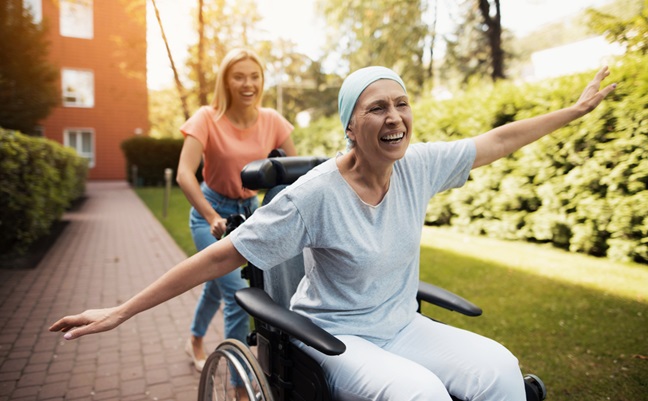 A,Woman,With,Cancer,Is,Sitting,In,A,Wheelchair.,She