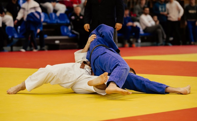 Match,Judo,Judokas,On,Tatami,In,Gym,With,Tribune,Audience