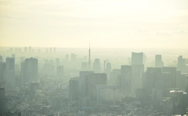 Misty Tokyo cityscape, yellowish tint of sunlight