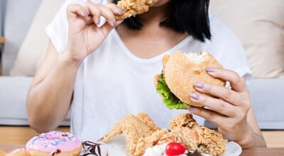 Binge,Eating,Disorder,Concept,With,Woman,Eating,Fast,Food,Burger,