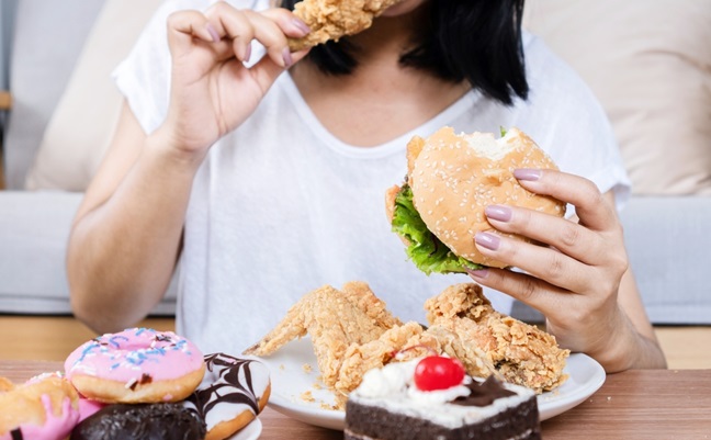 Binge,Eating,Disorder,Concept,With,Woman,Eating,Fast,Food,Burger,
