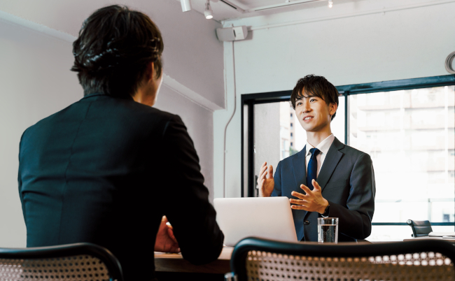 Two,Men,,A,Businessman,In,A,Suit,That,Meets,Business