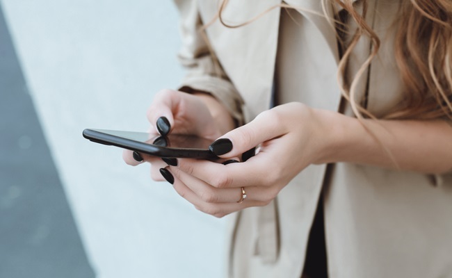 Young,Pretty,Woman,Posing,In,The,Street,With,Phone,,Outdoor