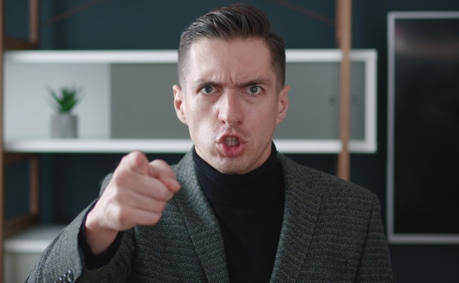 Close-up,Angry,Businessman,Shouting,And,Pointing,At,Camera.,Portrait,Of