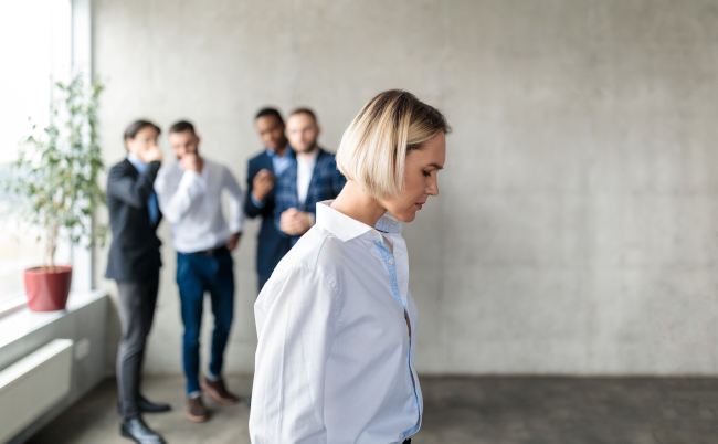 Workplace,Bullying,And,Sexism.,Male,Colleagues,Whispering,Behind,Back,Of