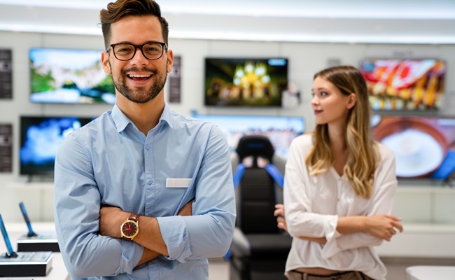 Happy,Seller,Man,Helping,To,Woman,To,Buy,A,New