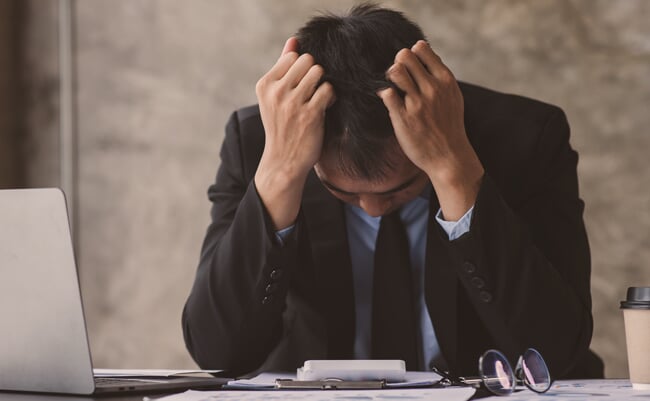 Stress man, business people and work concept, a tired Asian businessman with eyeglasses in office