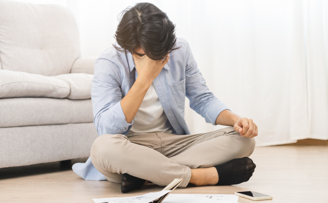 Financial,,Owe,Asian,Man,,Male,Sitting,On,Floor,Home,,Stressed