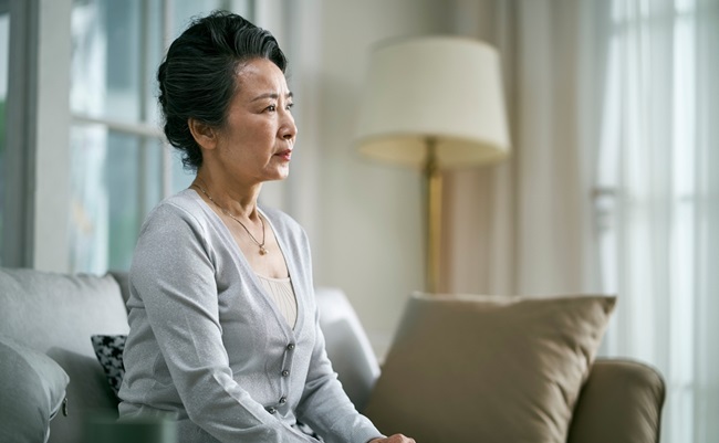 Side,View,Of,Sad,Senior,Asian,Woman,Sitting,Alone,On