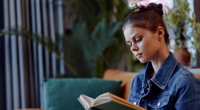 Relaxing,At,Home,Woman,Reading,Book,On,Couch,In,Front