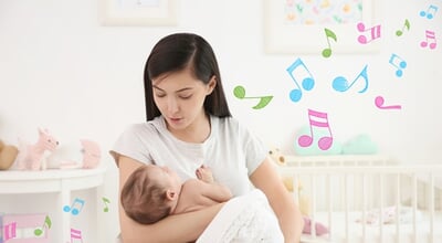 Mother,With,Sleeping,Baby,At,Home.,Lullaby,Songs,And,Music
