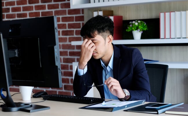 Young,Asian,Businessman,With,Frustrated,Expression,While,Working,With,Computer