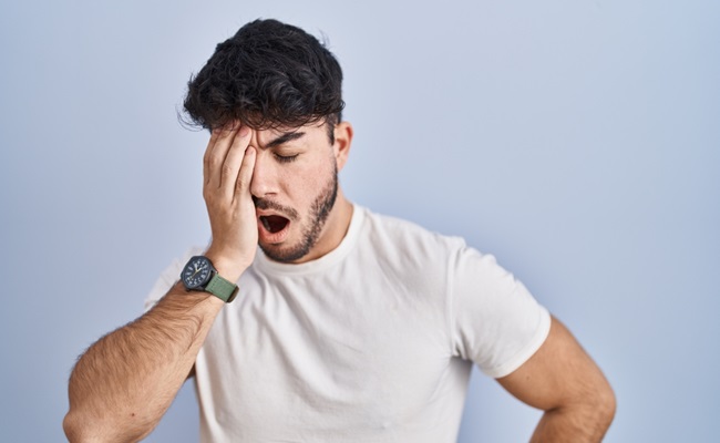 Hispanic,Man,With,Beard,Standing,Over,White,Background,Yawning,Tired