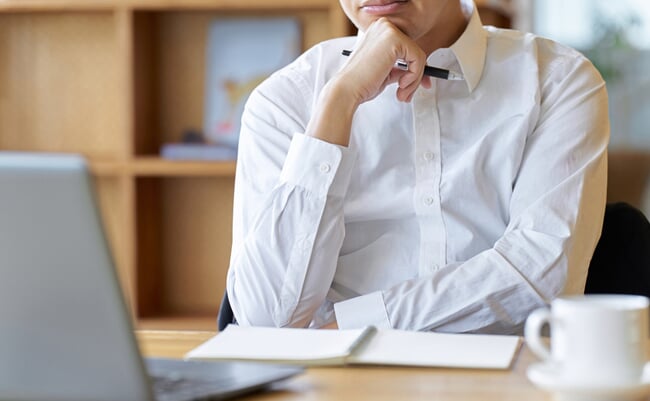 Asian businessman thinking while working at a cafe