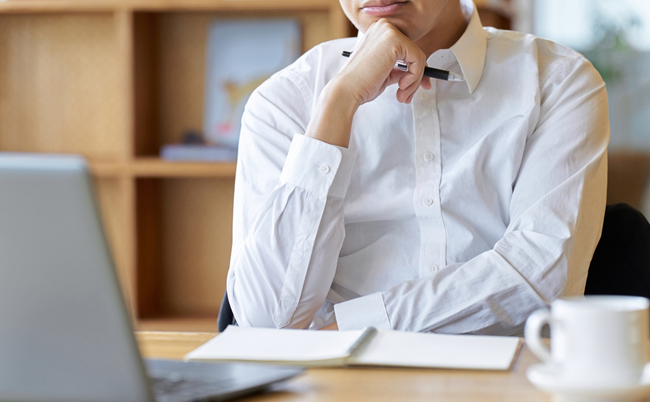 Asian,Businessman,Thinking,While,Working,At,A,Cafe