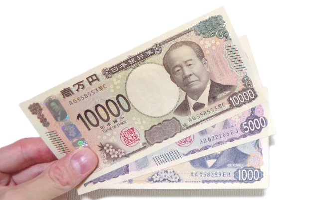 Hand,Holding,New,Japanese,Banknotes,Against,White,Background