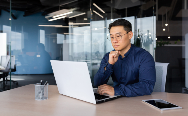 Serious,Thinking,Asian,Businessman,Working,Inside,Modern,Office,,Mature,Man