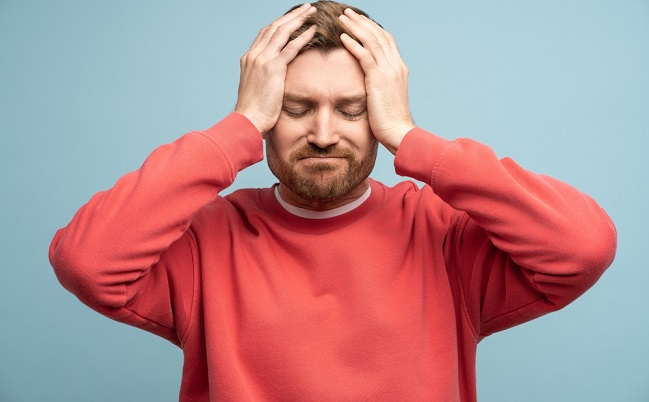 Irritated,Man,With,Closed,Eyes,Holds,Head,Feeling,Discomfort,Due