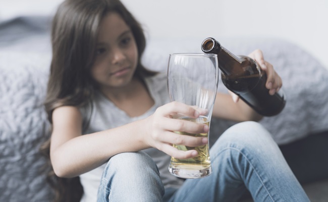 Children's,Alcoholism.,A,Little,Dark-haired,Girl,Sits,Leaning,On,The