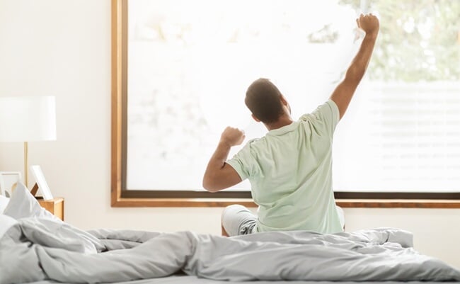 Back,View,Of,Full-rested,African,American,Man,Wearing,Pajamas,Sitting
