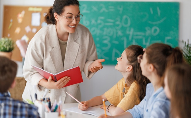 Happy,Kids,And,Teacher,At,School.,Woman,And,Children,Are