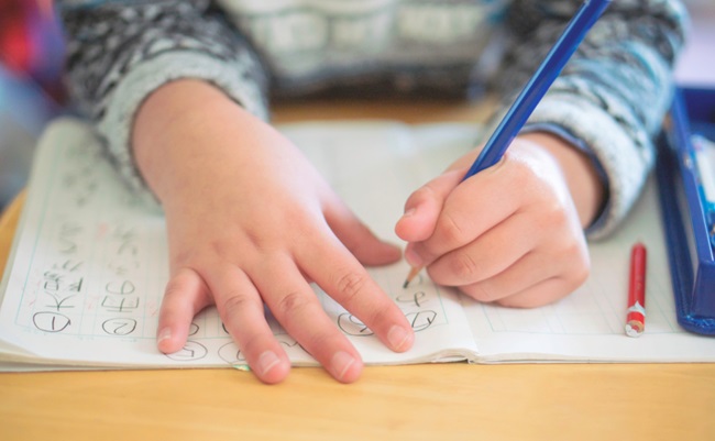 Japanese,Boy,(elementary,School),Doing,Homework,,Kanji,,Left,Handed.,Writing
