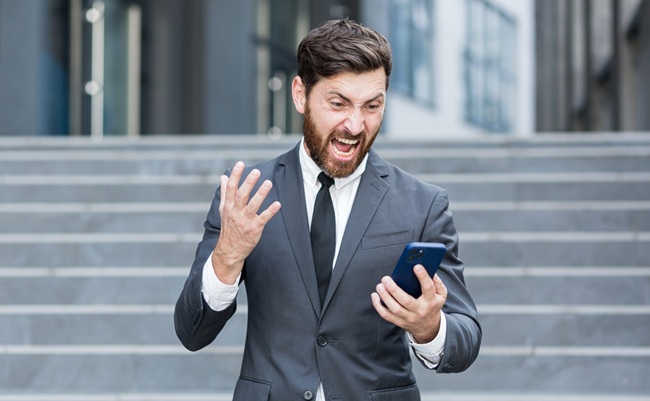 Angry,Male,Businessman,Cry,Talking,On,The,Phone,Outside,Business