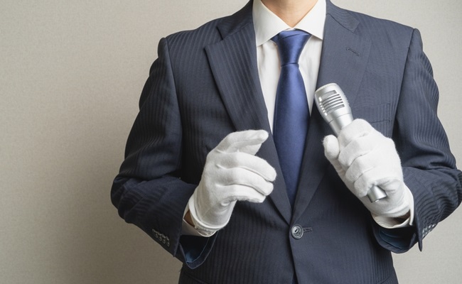 A,Man,Speaking,Into,A,Microphone.,A,Man,In,A