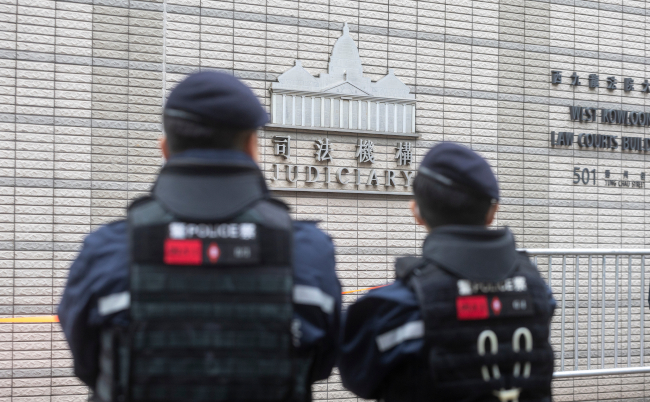 Dec,18,2023,,hong,Kong.police,Officers,Stand,Guard,Outside,The