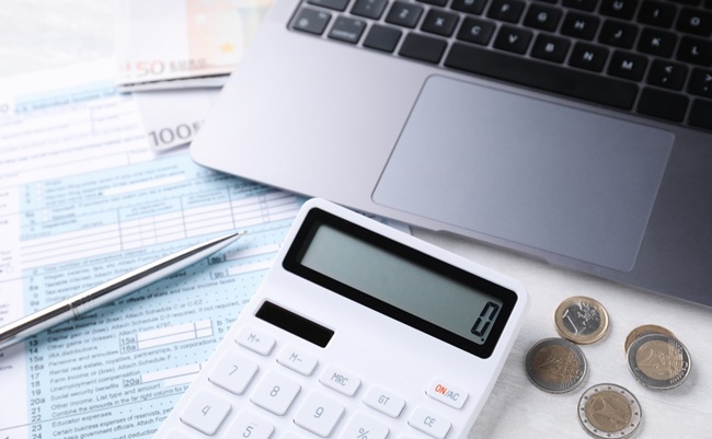 Tax,Accounting.,Calculator,,Money,,Pen,,Document,And,Laptop,On,Light