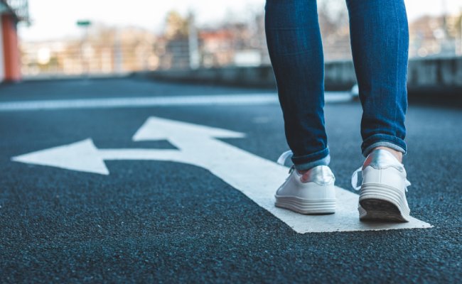 Make,Decision,Which,Way,To,Go.,Walking,On,Directional,Sign