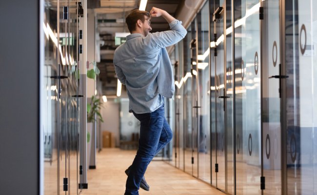 Overjoyed,Funny,Young,Business,Man,Jumping,In,Hallway,Celebrate,Success