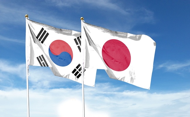 Japan,Flag,And,South,Korea,Flag,On,Cloudy,Sky.,Waving