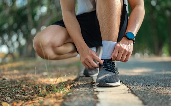 Close,Up,-,Running,Shoes,Runner,Man,Tying,Laces,For