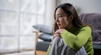 Young,Woman,Is,Feeling,Sad,While,Sitting,Alone,By,The