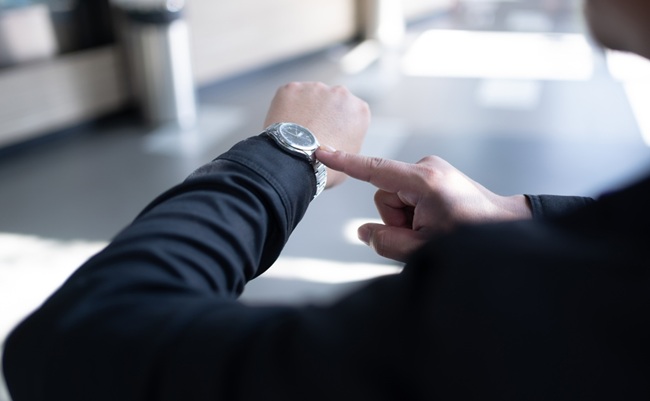 A,Person,In,Black,Sleeve,Looking,And,Pointing,At,His