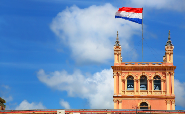 National,Flag,Flying,Above,Presidential,Palace,In,Asuncion,,Paraguay.,It