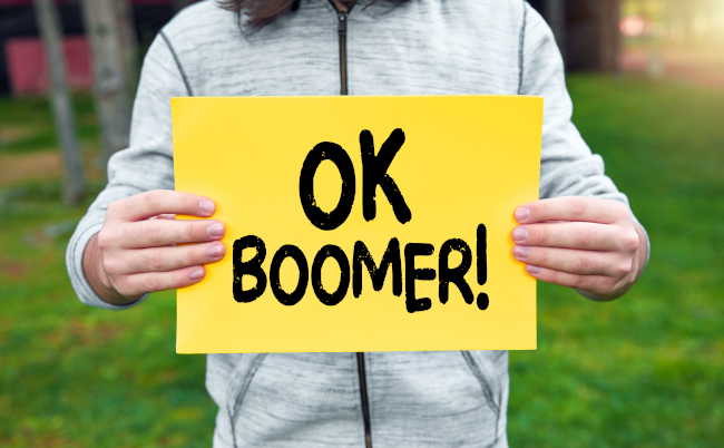 Teenager,Holds,A,Banner,With,The,Word,Ok,Boomer,Against