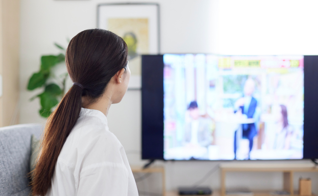 Back,View,Of,A,Japanese,Woman,Watching,Tv,In,The
