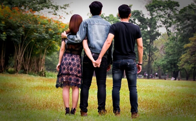 Love,Triangle.,Young,Woman,In,Relationship,With,Two,Men.back,View