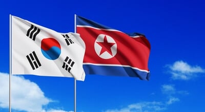 Wavy,South,Korea,And,North,Korea,Flags,And,Blue,Sky