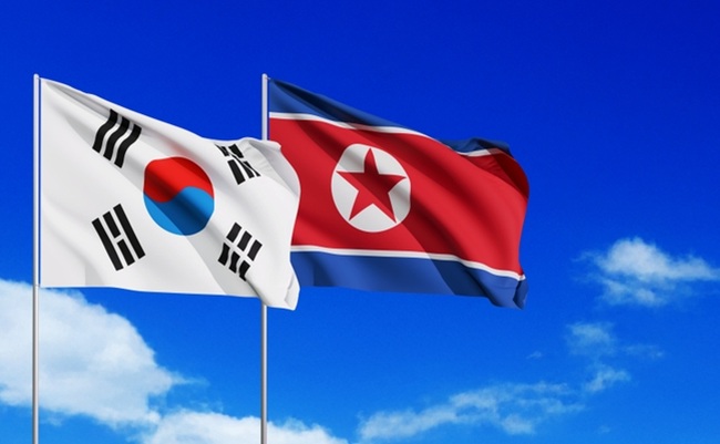 Wavy,South,Korea,And,North,Korea,Flags,And,Blue,Sky