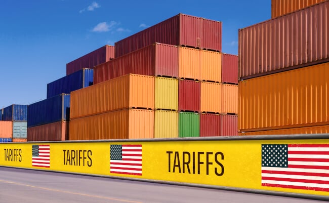 Stacked,Shipping,Containers,Behind,Tariff,Barriers,With,Us,Flags,,Symbolizing