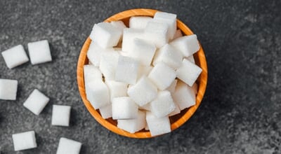 A,Bowl,Filled,With,Square,White,Sugar,Cubes,Sits,On